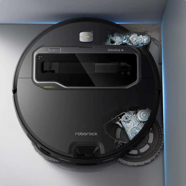 Vue de dessus d'un aspirateur robot noir avec un panneau transparent montrant les engrenages internes.